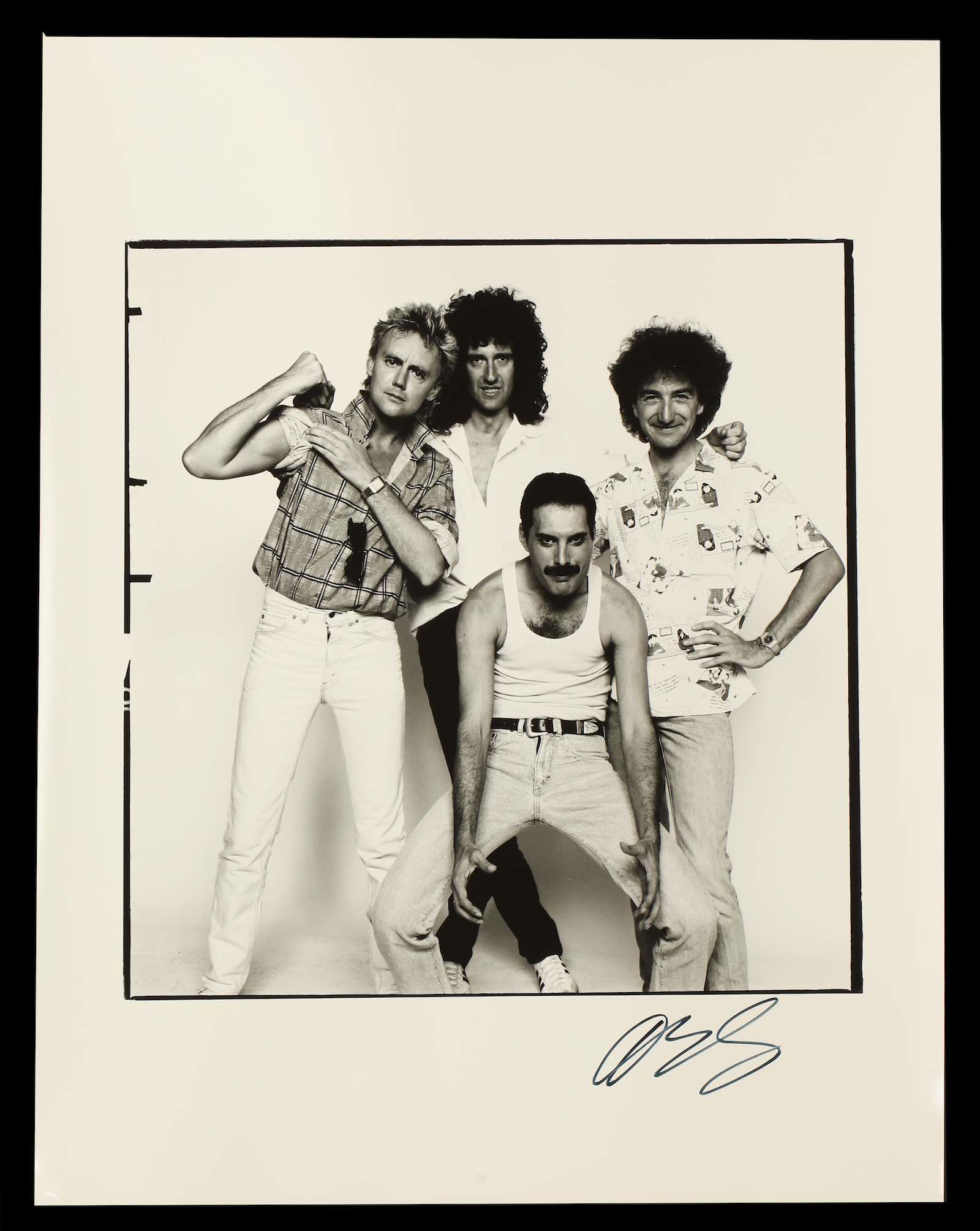 Four members of Queen (again signed on reverse by Freddie Mercury, Brian May Roger Taylor and John Deacon)